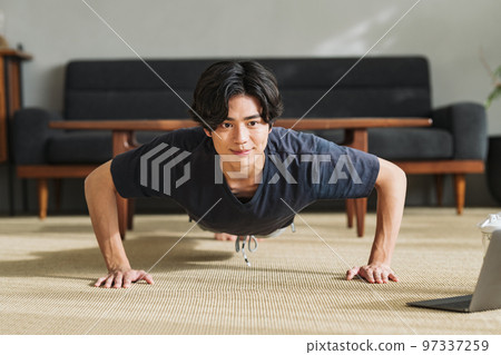 A man doing muscle training at home 97337259