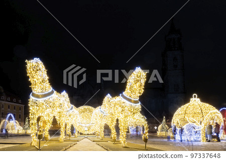 Scenic art light led lamp decoration figures of horse carriage, christmas tree bowl on Magdeburg Dom square. Light world lichterwelt city new year xmas in Germany Saxony-Anhalt Scenic art light led lamp decoration figures of horse carriage, christmas tree bowl on Magdeburg Dom square. Light world lichterwelt city new year xmas in Germany Saxony-Anhalt 97337648