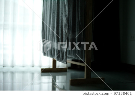 Selective focus on the trowel hanging on the wooden rack for drying after use in the room 97338461