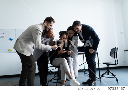 Cheerful startup business team rejoicing success at office Cheerful startup business team rejoicing success at office 97338467