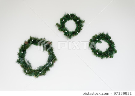 Christmas wreaths with fir tree on white wall wall 97339931