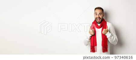 Winter holidays and shopping concept. Cheerful bearded man like everything, showing thumbs up in approval, standing amazed against white background 97340616