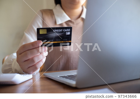 Women purchasing online using credit card payments via laptop, Shopping online and banking online concept. Women purchasing online using credit card payments via laptop, Shopping online and banking online concept. 97343666