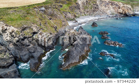 Steep cliffs on the coast. Turquoise waters of the Atlantic Ocean. Natural beauties of Ireland, West Cork. The rocky coast of the Celtic Sea. 97344220