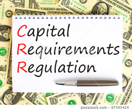 CRR capital requirements regulation symbol. Words CRR capital requirements regulation on white note on background from dollar bills. Business CRR capital requirements regulation concept. Copy space. 97345424