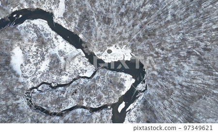 River delta floodplain winter snow meander drone aerial inland video shot in sandy sand alluvium freezing cold frost, benches forest and lowlands wetland swamp, quadcopter view flying fly flight show 97349621