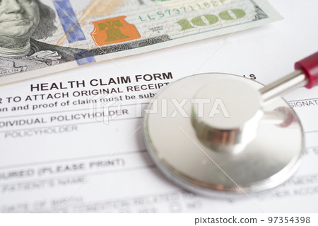 Health claim form with stethoscope and US dollar banknotes, insurance accident medical concept. 97354398