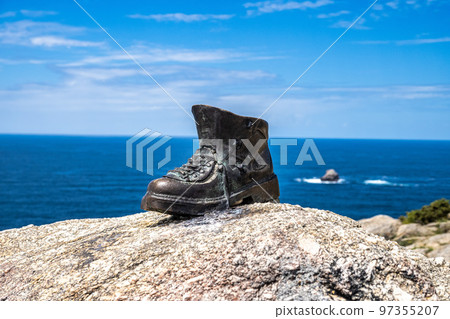 Used boots shoes at the end of Saint James Way in Finisterre Fisterra Camino de Santiago Spain 97355207