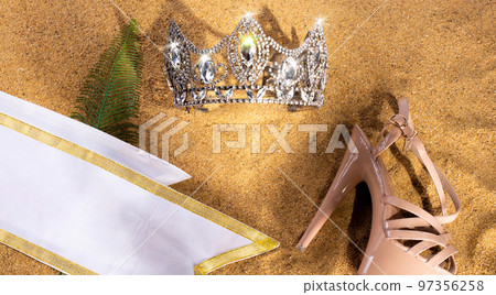 Diamond Crown, High heel shoes, Sash for Princess Miss Pageant Beauty Contest on Sand Beach in Tropical Island beautiful summer sun on golden find sand, studio shot copy space Diamond Crown, High heel shoes, Sash for Princess Miss Pageant Beauty Contest on Sand Beach in Tropical Island beautiful summer sun on golden find sand, studio shot copy space 97356258