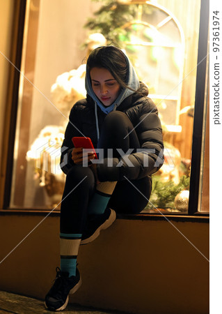 Portrait of a focused woman using a mobile phone outdoors 97361974