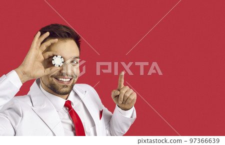 Cheerful man with one black and white poker chip isolated on red banner background. Cheerful man with one black and white poker chip isolated on red banner background. 97366639
