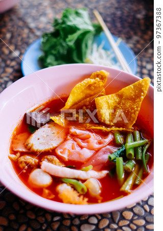 Close up of noodle in pink broth ( Yentafo ) Close up of noodle in pink broth ( Yentafo ) 97367388