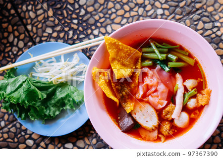 Close up of noodle in pink broth ( Yentafo ) Close up of noodle in pink broth ( Yentafo ) 97367390