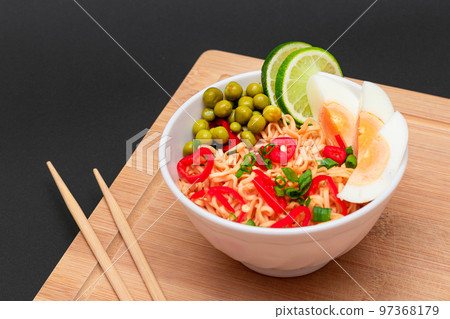 Beautiful Noodle Dish with Green Pea, Eggs, Red Hot Pepper, Greens and Lime 97368179