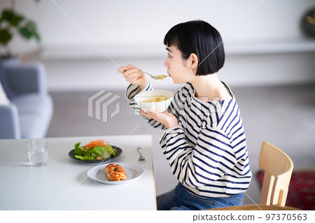 woman eating at home dining woman eating at home dining 97370563
