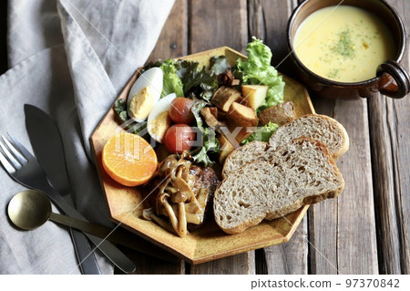 Mushroom hamburger steak, rye bread and plenty of vegetables on a plate lunch 97370842