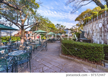 [Kyushu/Nagasaki] Open-air restaurant in front of the statues of Tamaki Miura and Puccini in Glover Garden. 97372447