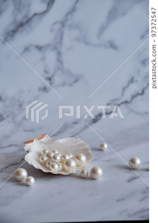 pearls in a shell on a marble background pearls in a shell on a marble background 97372547