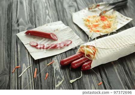 sausages wrapped in pita bread.preparation of Shawarma.photo with copy space sausages wrapped in pita bread.preparation of Shawarma.photo with copy space 97372696