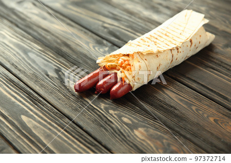 homemade sausages in pita bread on wooden background.photo with copy space homemade sausages in pita bread on wooden background.photo with copy space 97372714