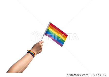 Isolate of female hand with LGBT bracelet and LGBT flag 97373167