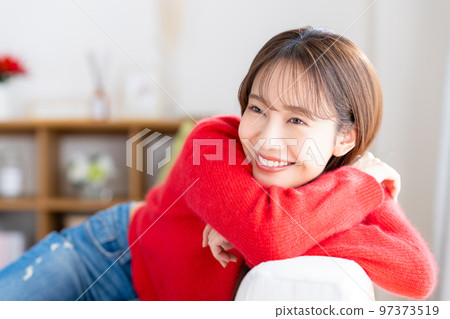 Young woman relaxing in the living room Young woman relaxing in the living room 97373519