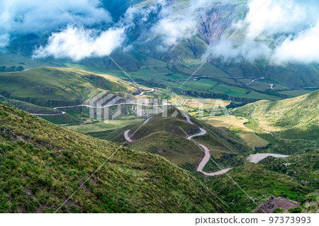 winding mountain roads in the Andes Mountains with a sky overcast with clouds. winding mountain roads in the Andes Mountains with a sky overcast with clouds. 97373993