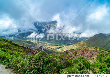 winding mountain roads in the Andes Mountains with a sky overcast with clouds.  97373997