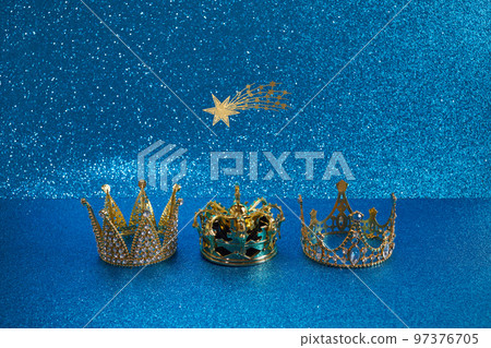 Three crowns of the three wise men with star over blue background. For Reyes Magos day and Happy Epiphany day. 97376705