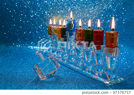 Jewish holiday Hanukkah background with menorah and dreidel with letters Gimel and Nun. Jewish holiday Hanukkah background with menorah and dreidel with letters Gimel and Nun. 97376737