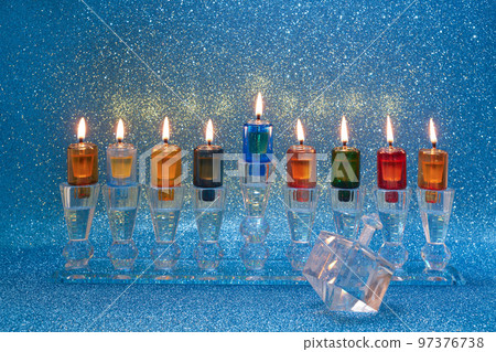 Jewish holiday Hanukkah background with menorah and dreidel with letters Gimel and Nun. Jewish holiday Hanukkah background with menorah and dreidel with letters Gimel and Nun. 97376738