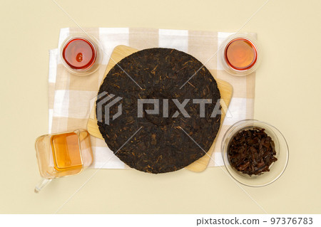 Black puer tea, dry pu erh tea leaves on a beige background, tea ceremony. Flat lay 97376783