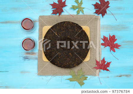 Black puer tea, dry pu erh tea leaves on blue background, tea ceremony. Flat lay 97376784