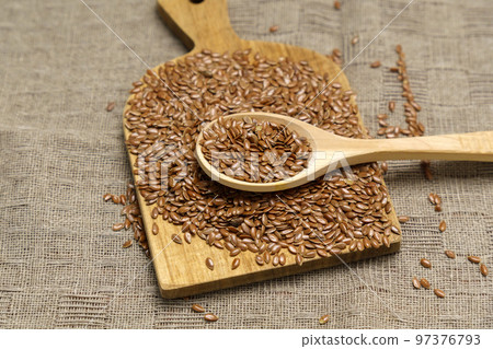 Linum usitatissimum is the scientific name of brown flax seeds. Close-up, selective focus 97376793