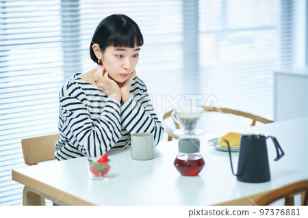 Young woman drinking coffee in the room Young woman drinking coffee in the room 97376881