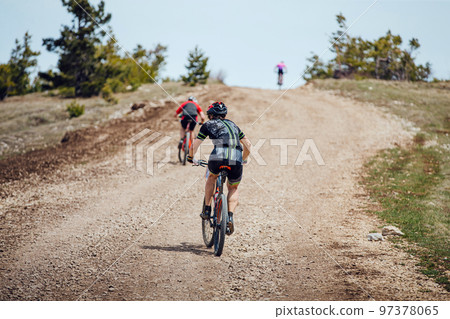 back men athletes on mountainbike riding uphill 97378065
