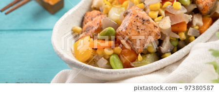 Fresh salmon cube with stir-fried mixed vegetables. 97380587