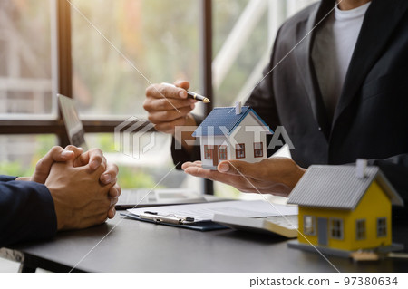 Considering buying a home, investing in real estate. Broker signs a sales agreement. agent, lease agreement, successful deal Considering buying a home, investing in real estate. Broker signs a sales agreement. agent, lease agreement, successful deal 97380634