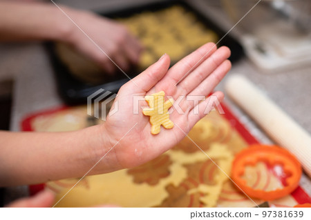 Hands of parent and child making homemade cookies 97381639