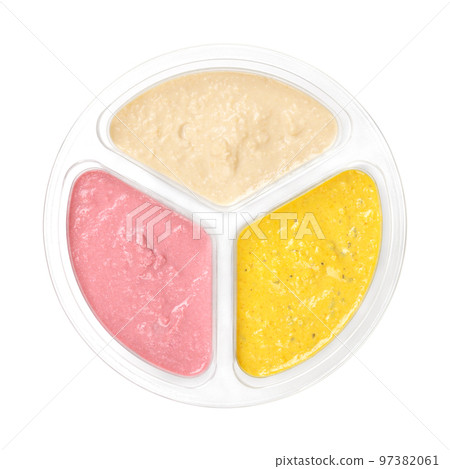 Hummus dip varieties in a clear plastic container. Natural hummus with cumin, yellow curry and red beetroot. Middle Eastern dip, spread made of cooked chickpeas, blended with tahini, garlic and lemon. 97382061