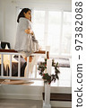 Beautiful woman gray blanket staying at home during cold weather Christmas wreath stairs Decoration 97382088