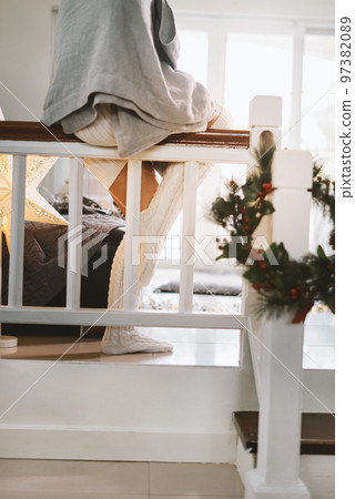 Beautiful woman gray blanket staying at home during cold weather Christmas wreath stairs Decoration Beautiful woman gray blanket staying at home during cold weather Christmas wreath stairs Decoration 97382089