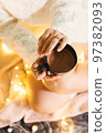 Top view hands holding hot beverage in black mug standing on knees. Top view Christmas New Year 97382093