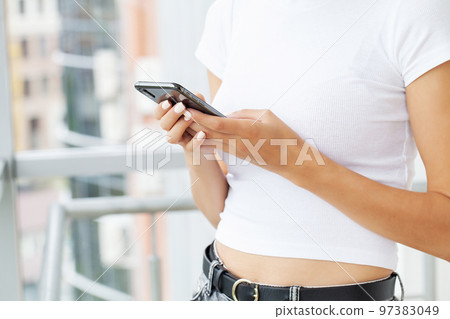 Woman holding smart phone chatting in social media Woman holding smart phone chatting in social media 97383049