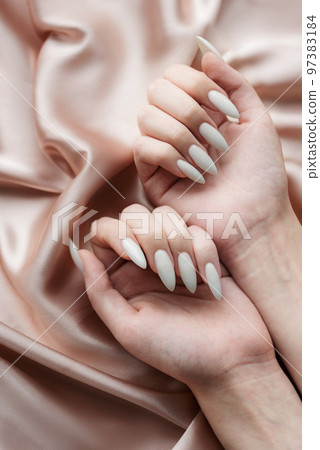 Hands of a young woman with white manicure on nails 97383184