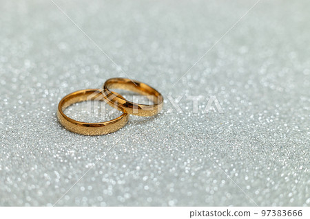 Will you marry me. Two golden wedding rings on silver glitter background. Engagement marriage proposal wedding concept. St. Valentine's Day postcard. Banner on valentines day. Copy space 97383666