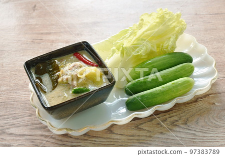 spicy Indo-Pacific king mackerel fish and chili sauce dipping fresh vegetable on plate 97383789
