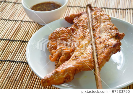 grilled chicken tight stabbing wooden stick on plate dipping with spicy sauce grilled chicken tight stabbing wooden stick on plate dipping with spicy sauce 97383790