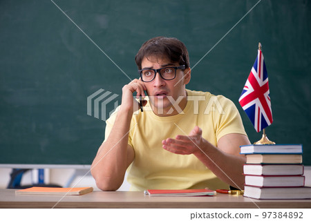 Young male English language teacher in the classroom Young male English language teacher in the classroom 97384892