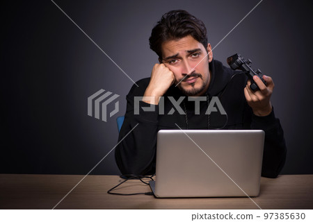 Young male gamer on grey background 97385630